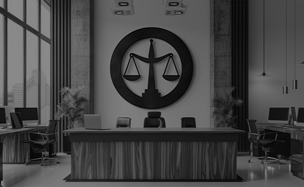 Black and white Modern law office interior with large wooden desk and a circular black scales of justice logo on the wall