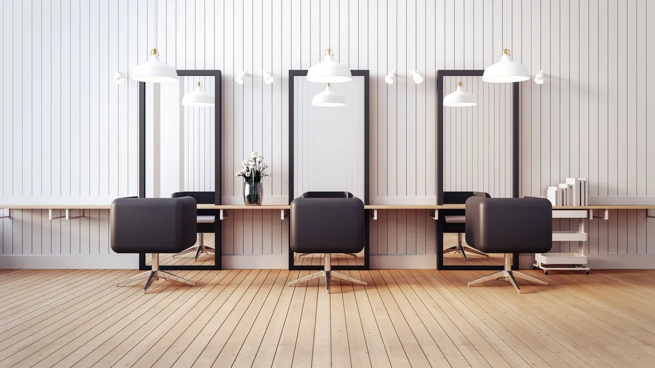 Modern hair salon interior with three black chairs, full-length mirrors, and white paneled walls