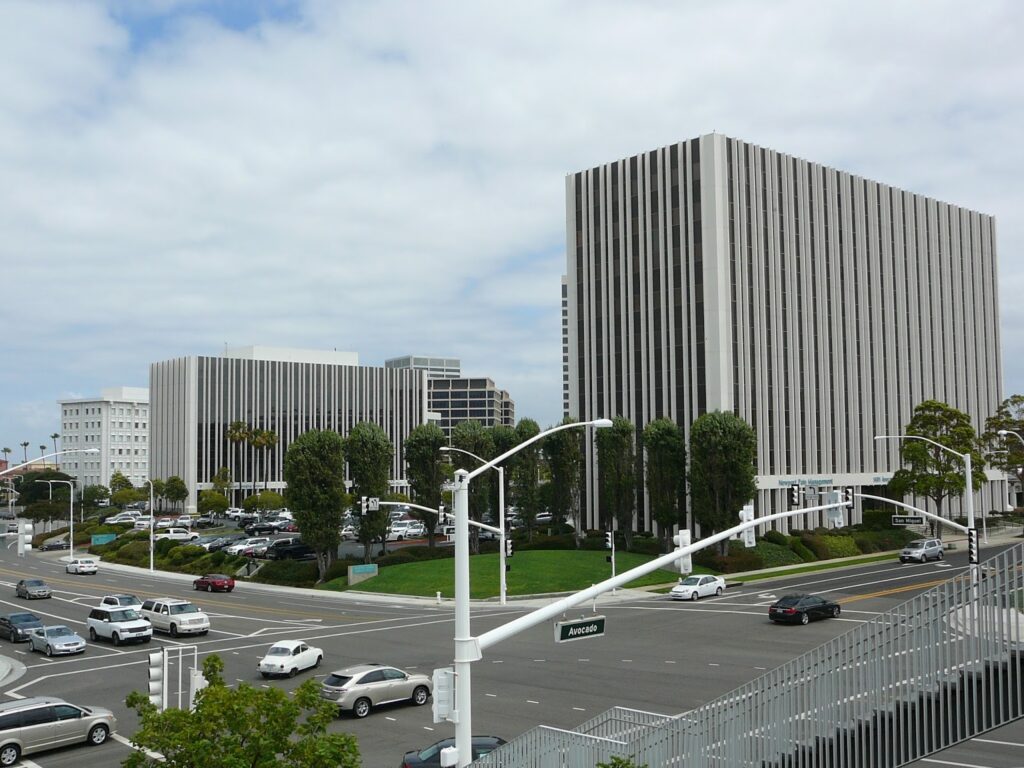 High-angle view of a modern professional office building at the intersection of Avocado Ave in Newport Beach, CA.